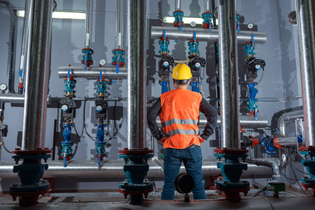 male-technician-is-checking-the-water-pumps-in-the-boiler-room